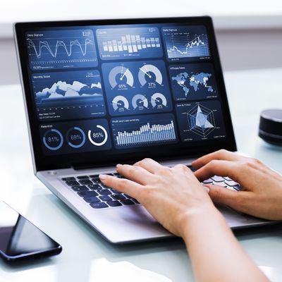 Person with laptop displaying graphical data